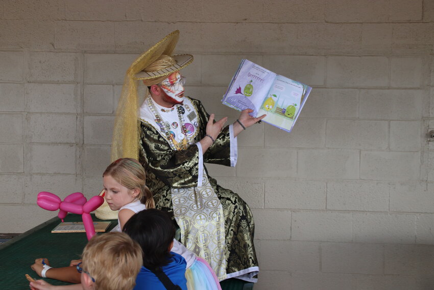 Sister Caskara reads a children's book for drag queen story hour at Douglas County PrideFest on Aug. 26. Organizers estimate more than 2,000 people attended this year.